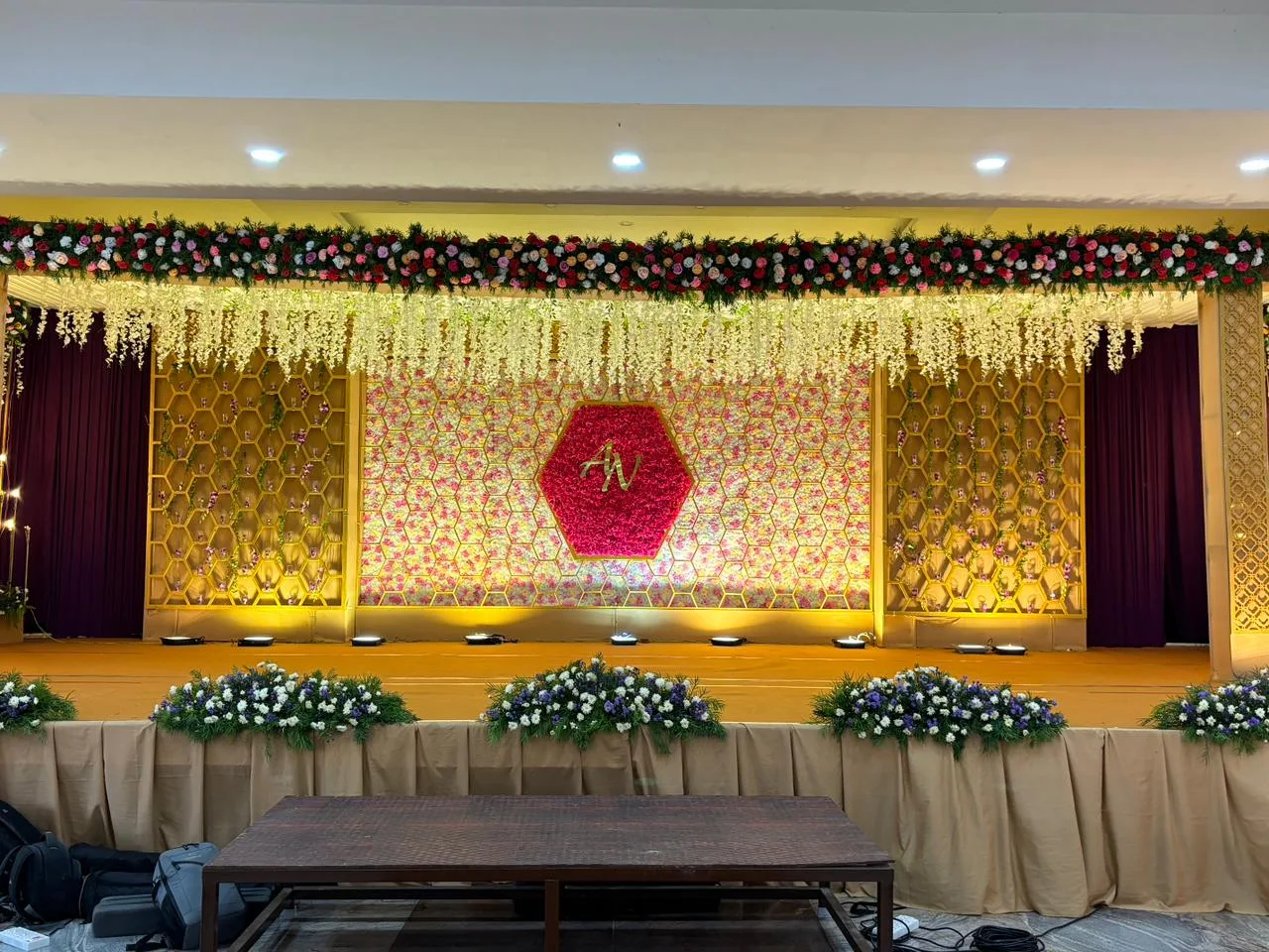 luxurious wedding venue hall with royal blue and gold decorations, crystal chandeliers, elegant wedding setup